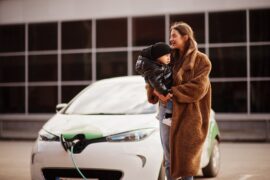 young-mother-with-child-charging-electro-car-at-the-electric-gas-station-min